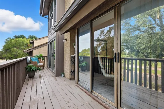 a view of a balcony with wooden floor