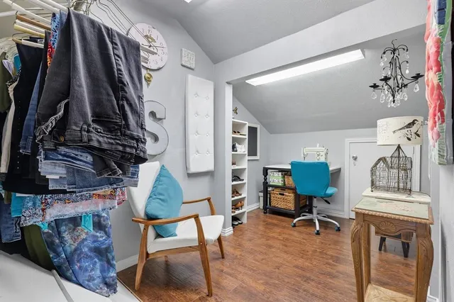 a view of a room with lots of stuff and hardwood floor