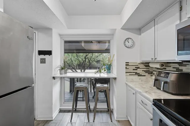 a kitchen with a stove and a refrigerator