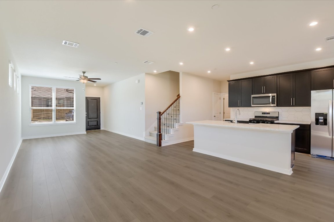 2500 Forest Creek Drive, Unit 2004 Round Rock, TX 78665 - Photo 27 of 27 a view of kitchen with microwave a refrigerator and wooden floor