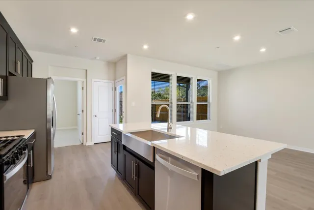 a kitchen with a sink appliances and cabinets