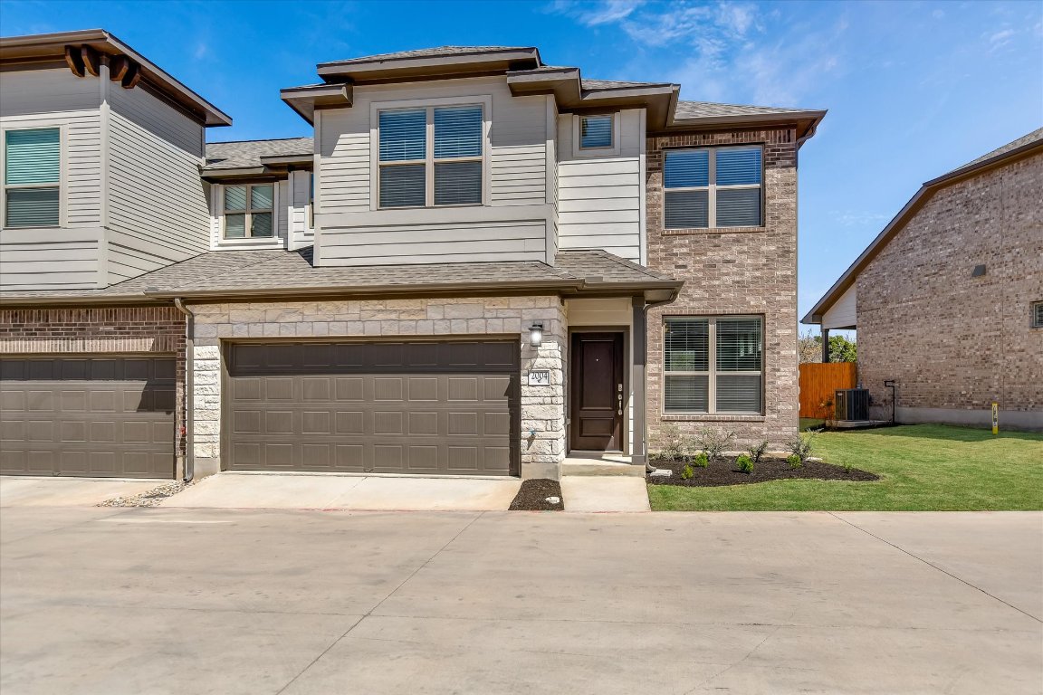 2500 Forest Creek Drive, Unit 2004 Round Rock, TX 78665 - Photo 1 of 27 a front view of a house with a yard and garage
