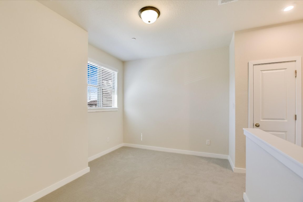 2500 Forest Creek Drive, Unit 2004 Round Rock, TX 78665 - Photo 20 of 27 a view of an empty room with a window and a bathroom