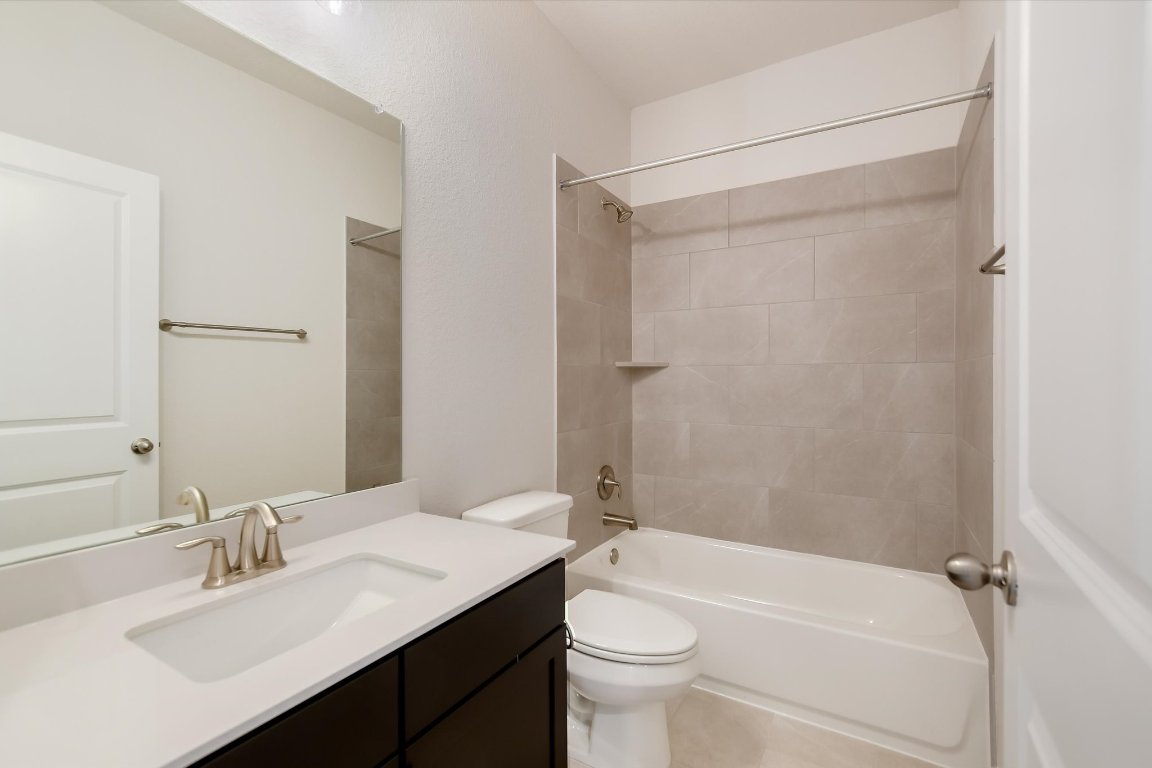 2500 Forest Creek Drive, Unit 2004 Round Rock, TX 78665 - Photo 22 of 27 a bathroom with a sink a toilet and shower