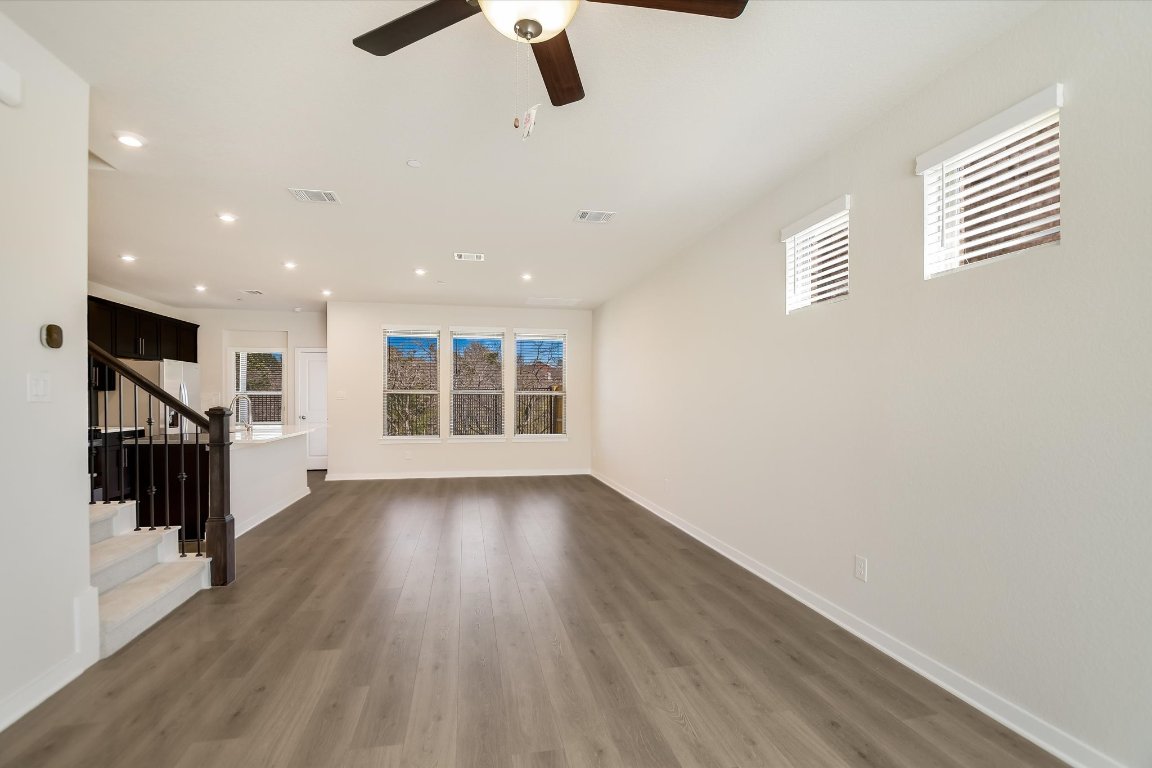 2500 Forest Creek Drive, Unit 2004 Round Rock, TX 78665 - Photo 3 of 27 an empty room with wooden floor fan and windows