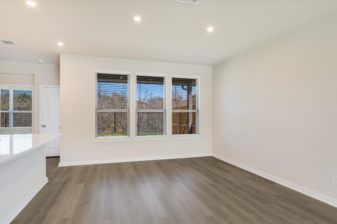 2500 Forest Creek Drive, Unit 2004 Round Rock, TX 78665 - Photo 4 of 27 an empty room with wooden floor and windows