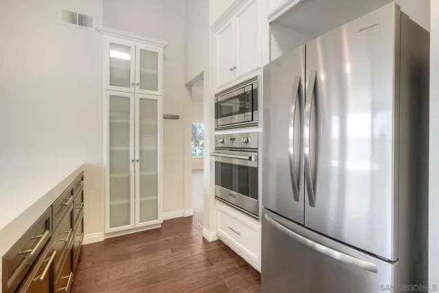 a kitchen with stainless steel appliances a refrigerator and a sink
