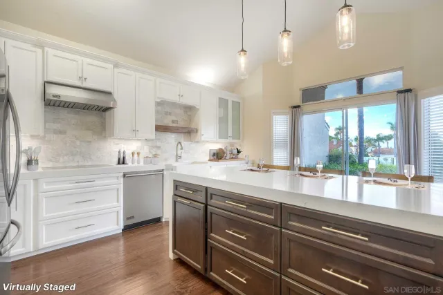 a kitchen with a sink cabinets and window
