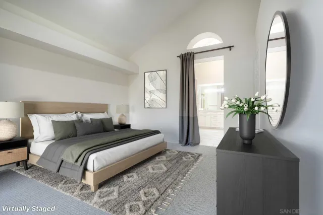 a bedroom with a bed lamp and a potted plant