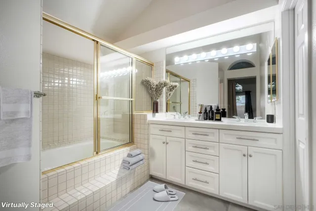 a spacious bathroom with a granite countertop sink mirror and shower