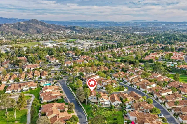 an aerial view of residential building with parking