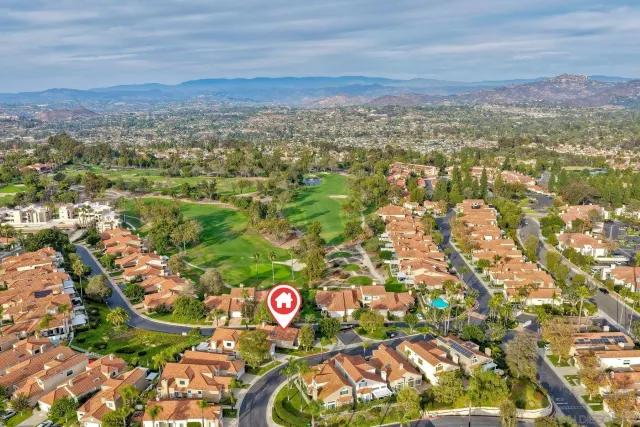 an aerial view of a house with a swimming pool