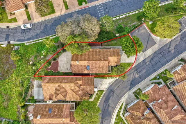 an aerial view of residential houses with outdoor space and street view