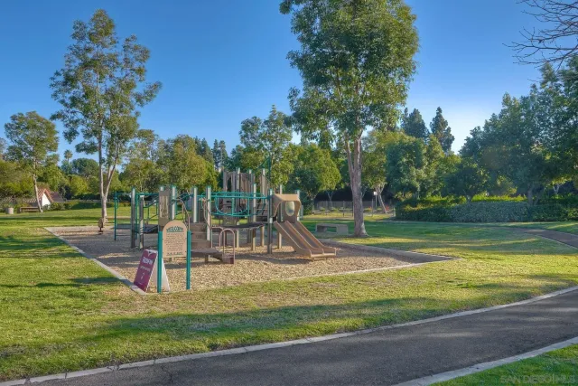 a view of a house with pool and a yard