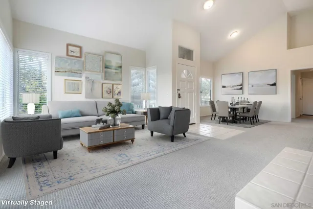 a living room with furniture and large windows