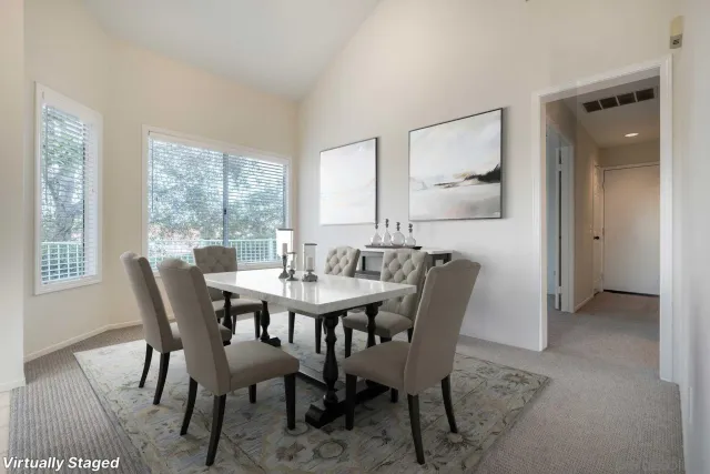 a view of a dining room with furniture and window