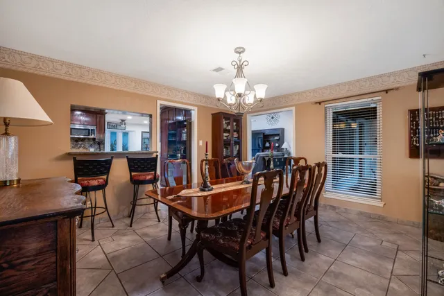 a view of a dining room with furniture and chandelier