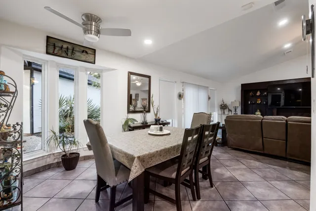 a dining room with furniture and window