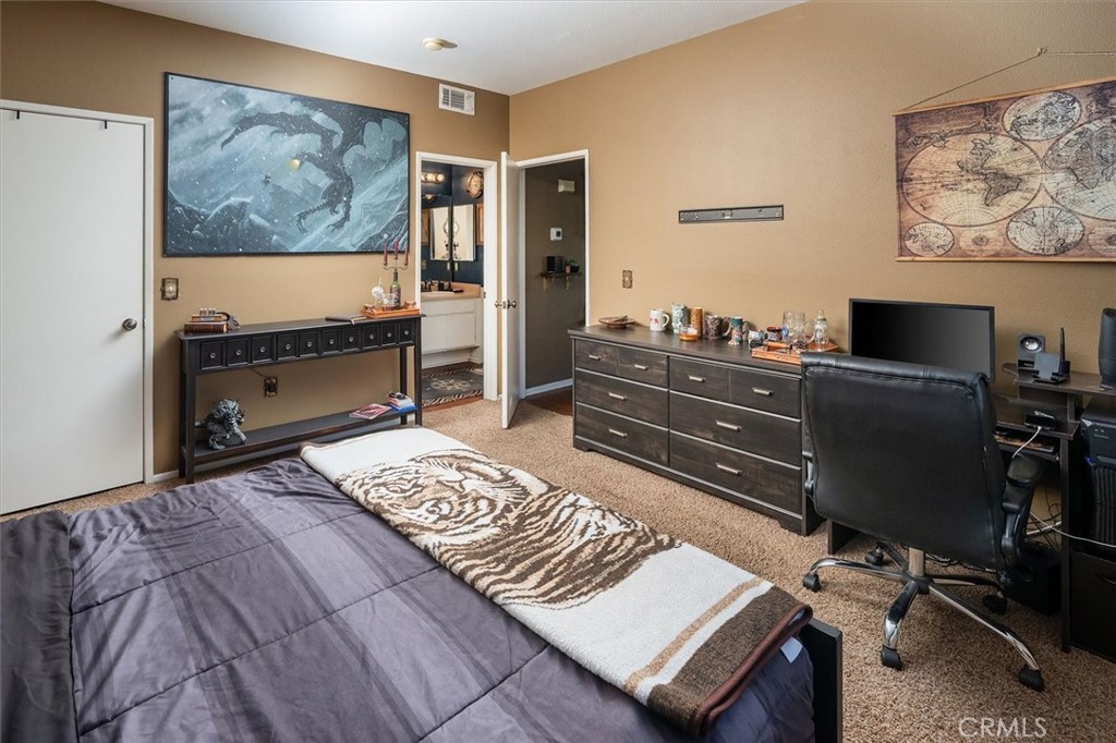 20000 Plum Canyon Road, Unit 1324 Saugus, CA 91350 - Photo 13 of 23 a bedroom with a bed and furniture