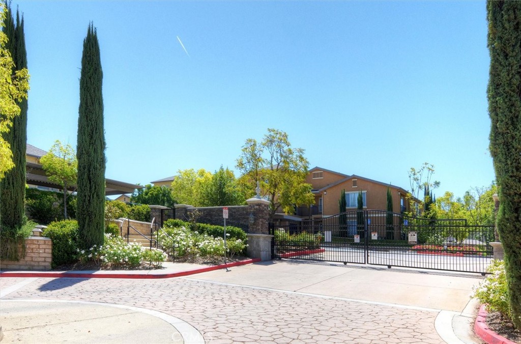 20000 Plum Canyon Road, Unit 1324 Saugus, CA 91350 - Photo 23 of 23 a front view of a house with a garden and pathway