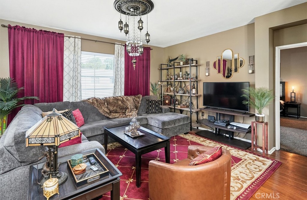 20000 Plum Canyon Road, Unit 1324 Saugus, CA 91350 - Photo 4 of 23 a living room with furniture a flat screen tv and a window