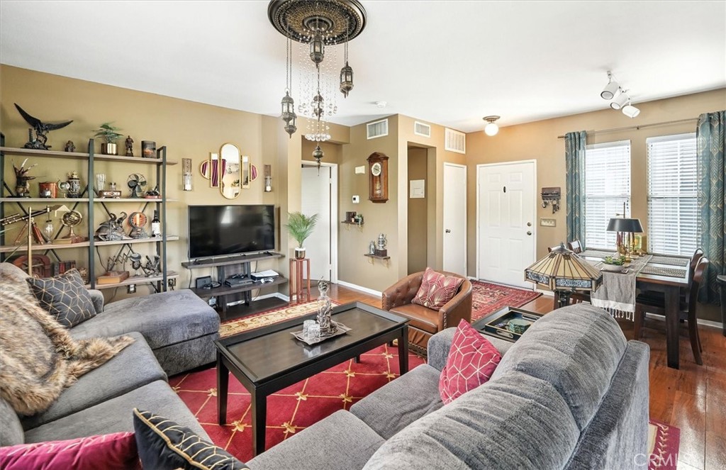 20000 Plum Canyon Road, Unit 1324 Saugus, CA 91350 - Photo 6 of 23 a living room with furniture a chandelier and a flat screen tv
