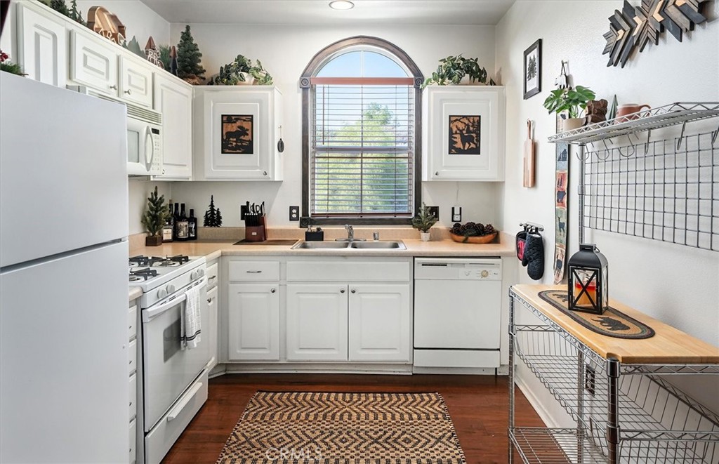 20000 Plum Canyon Road, Unit 1324 Saugus, CA 91350 - Photo 8 of 23 a kitchen with a sink stove and cabinets