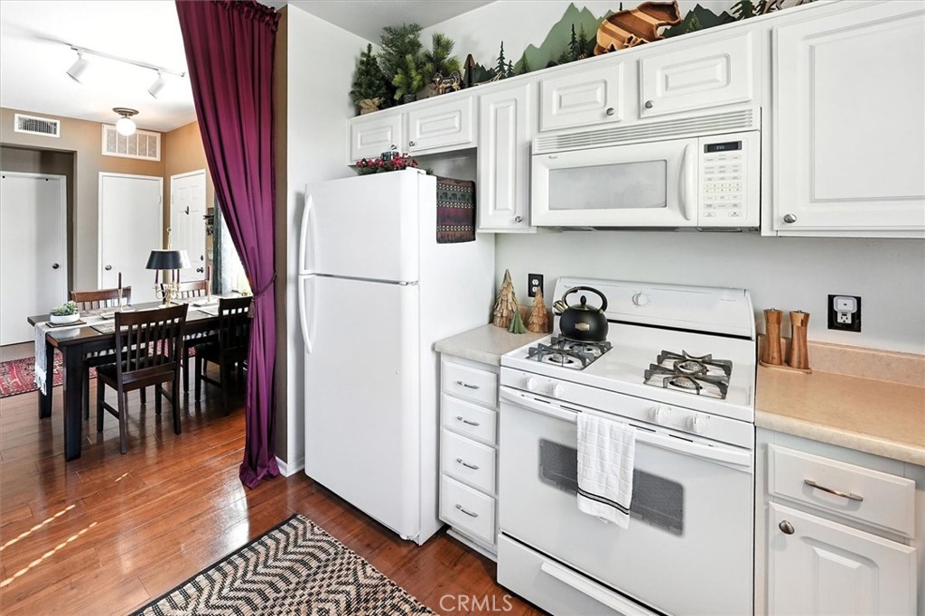 20000 Plum Canyon Road, Unit 1324 Saugus, CA 91350 - Photo 9 of 23 a kitchen with stainless steel appliances a stove a microwave and a refrigerator