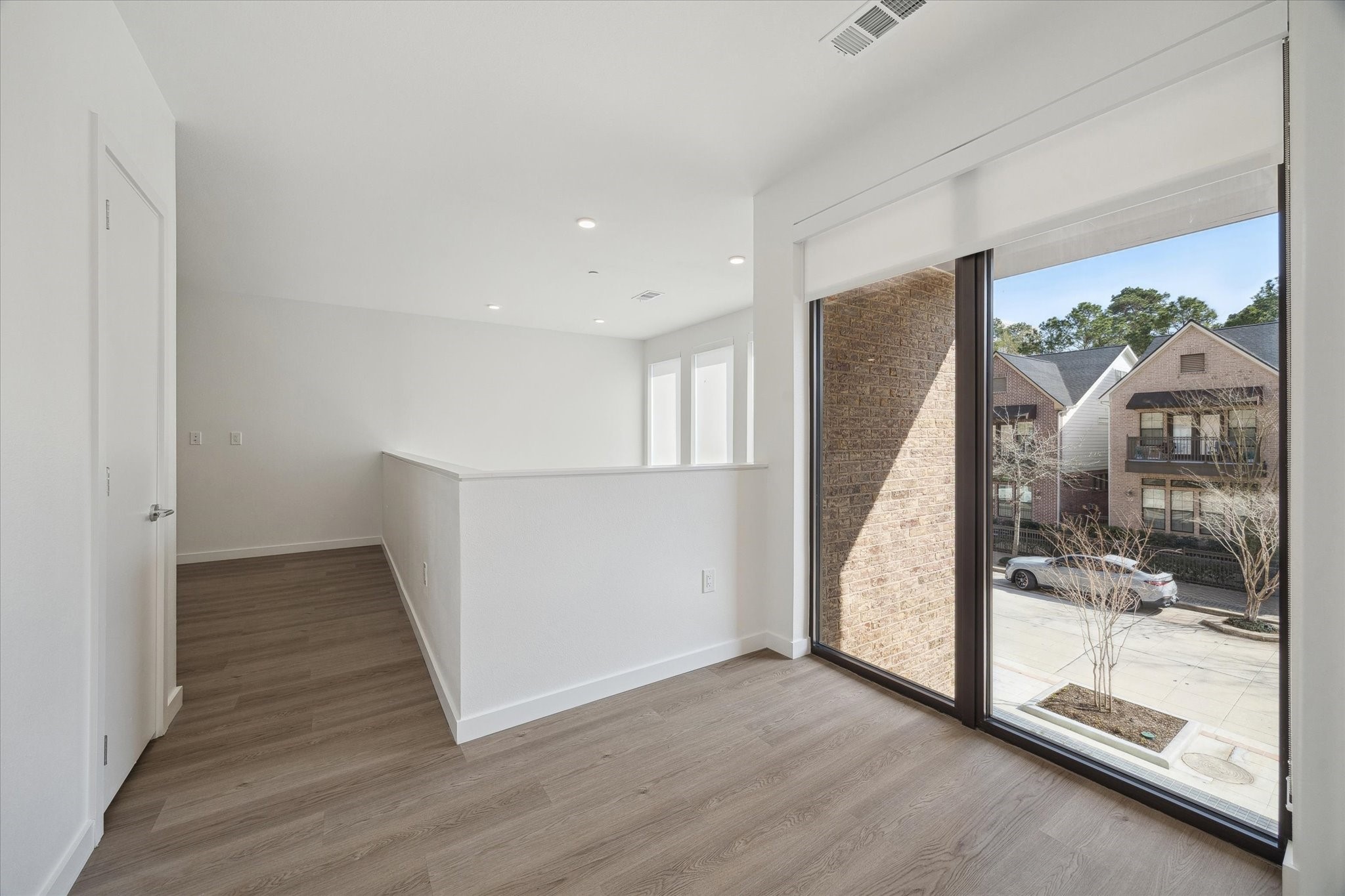 1 Riva Row, Unit 167 The Woodlands, TX 77380 - Photo 18 of 49 a view of a hallway with wooden floor and door
