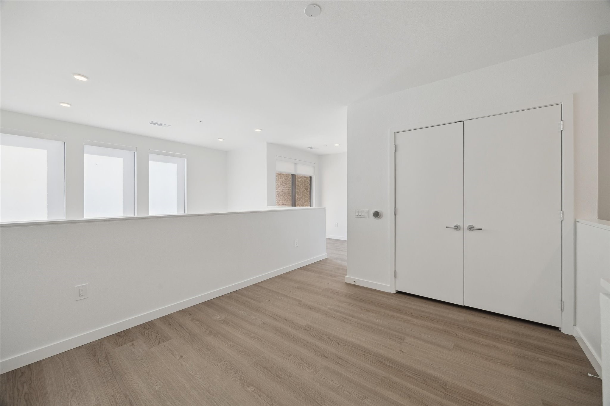1 Riva Row, Unit 167 The Woodlands, TX 77380 - Photo 19 of 49 a view of an empty room with wooden floor