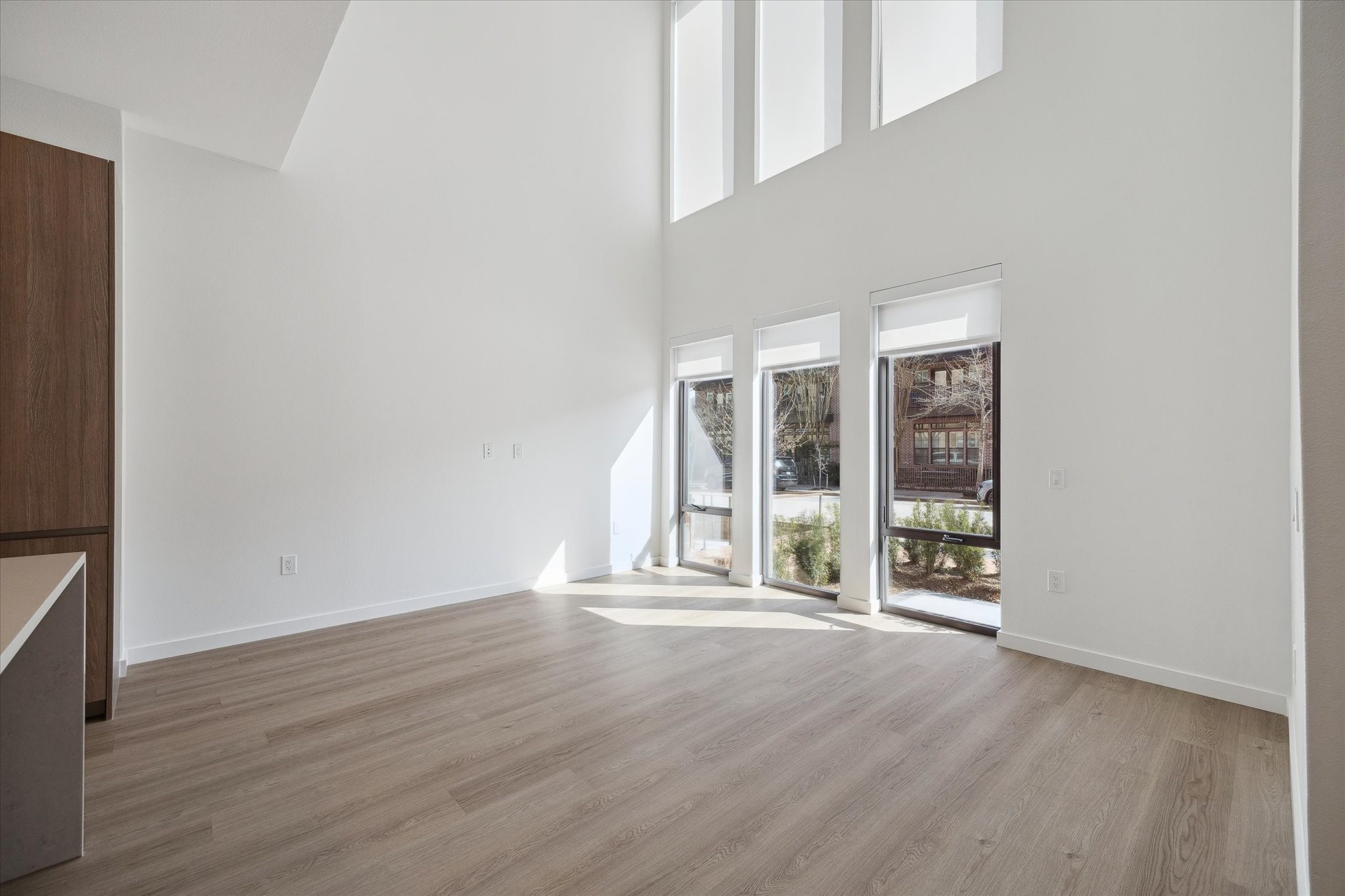 1 Riva Row, Unit 167 The Woodlands, TX 77380 - Photo 2 of 49 wooden floor and window in an empty room