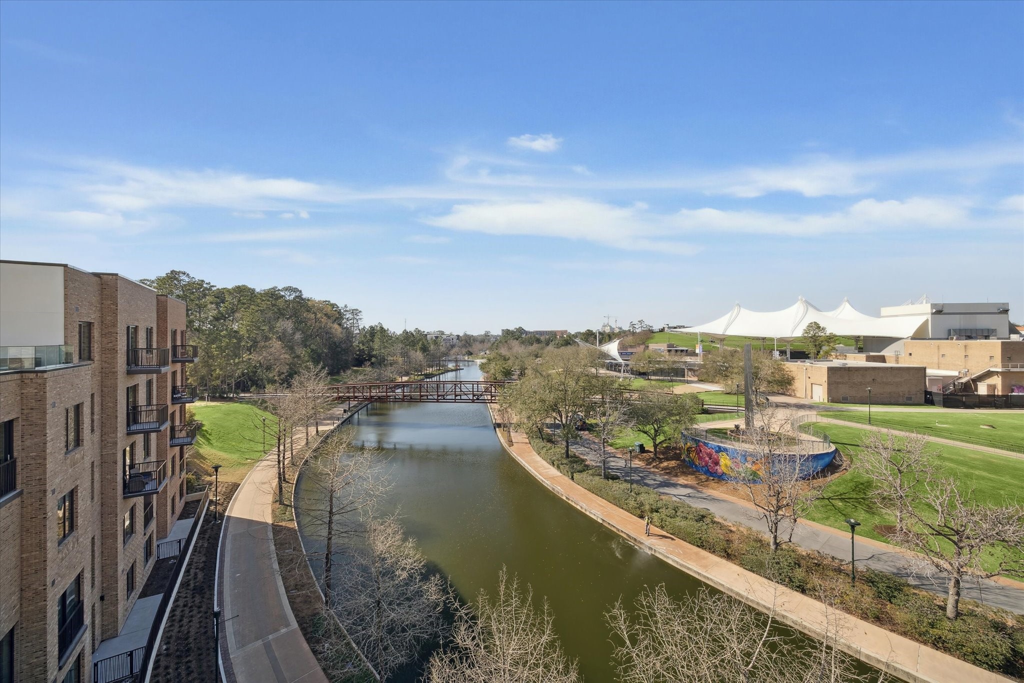 1 Riva Row, Unit 167 The Woodlands, TX 77380 - Photo 33 of 49 a view of a lake with a city