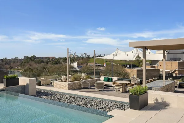 a view of a terrace with couches and city view