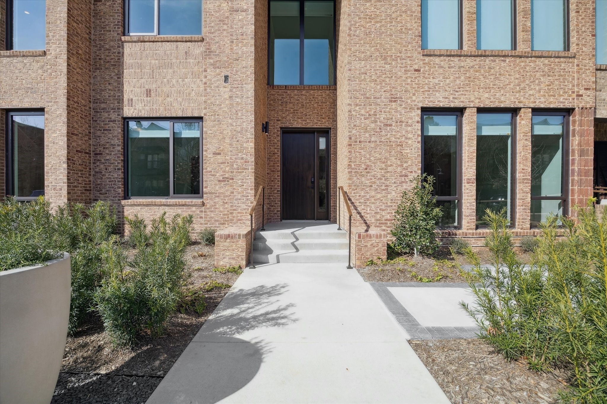 1 Riva Row, Unit 167 The Woodlands, TX 77380 - Photo 5 of 49 a front view of a brick house with a yard