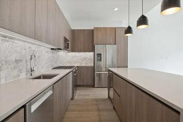 a kitchen with a sink and refrigerator