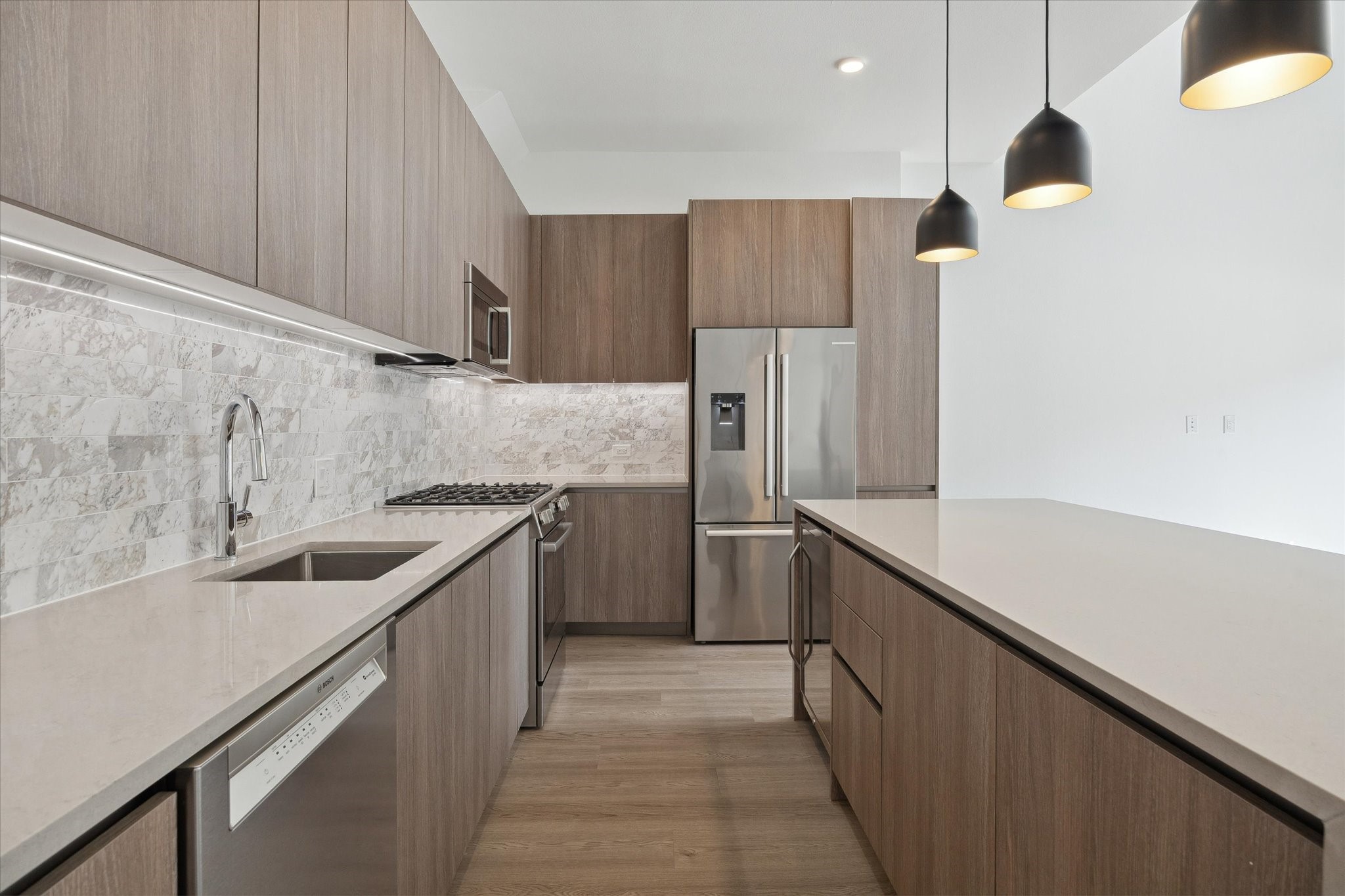1 Riva Row, Unit 167 The Woodlands, TX 77380 - Photo 6 of 49 a kitchen with a sink and refrigerator