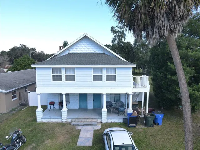 a aerial view of a house with swimming pool and porch