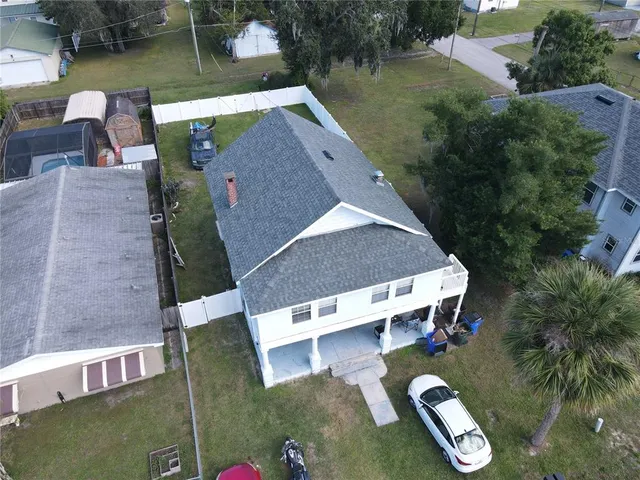 an aerial view of a house with garden space and lake view