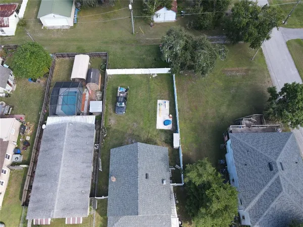 an aerial view of a house with outdoor space and parking