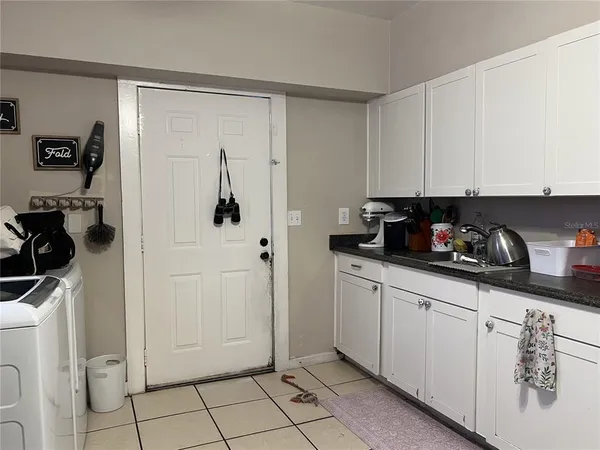 a view of a kitchen with white cabinets