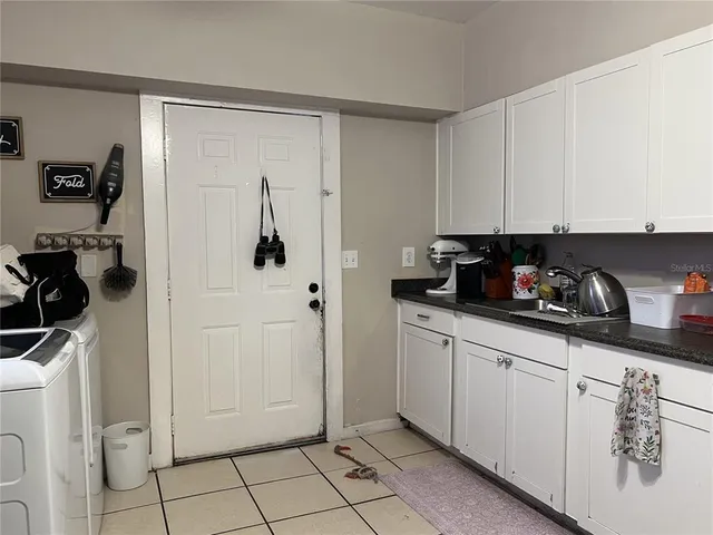 a view of a kitchen with white cabinets