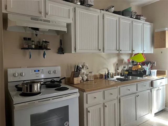 a kitchen with cabinets and appliances