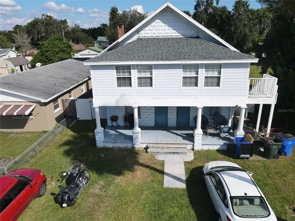 a aerial view of a house with swimming pool and porch