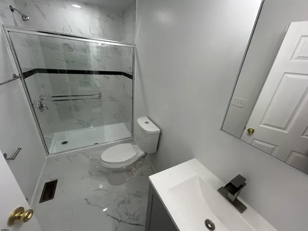 a bathroom with a sink toilet and shower