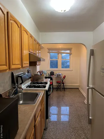 a kitchen with a sink appliances and cabinets