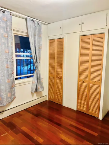 a view of entryway with wooden floor and door