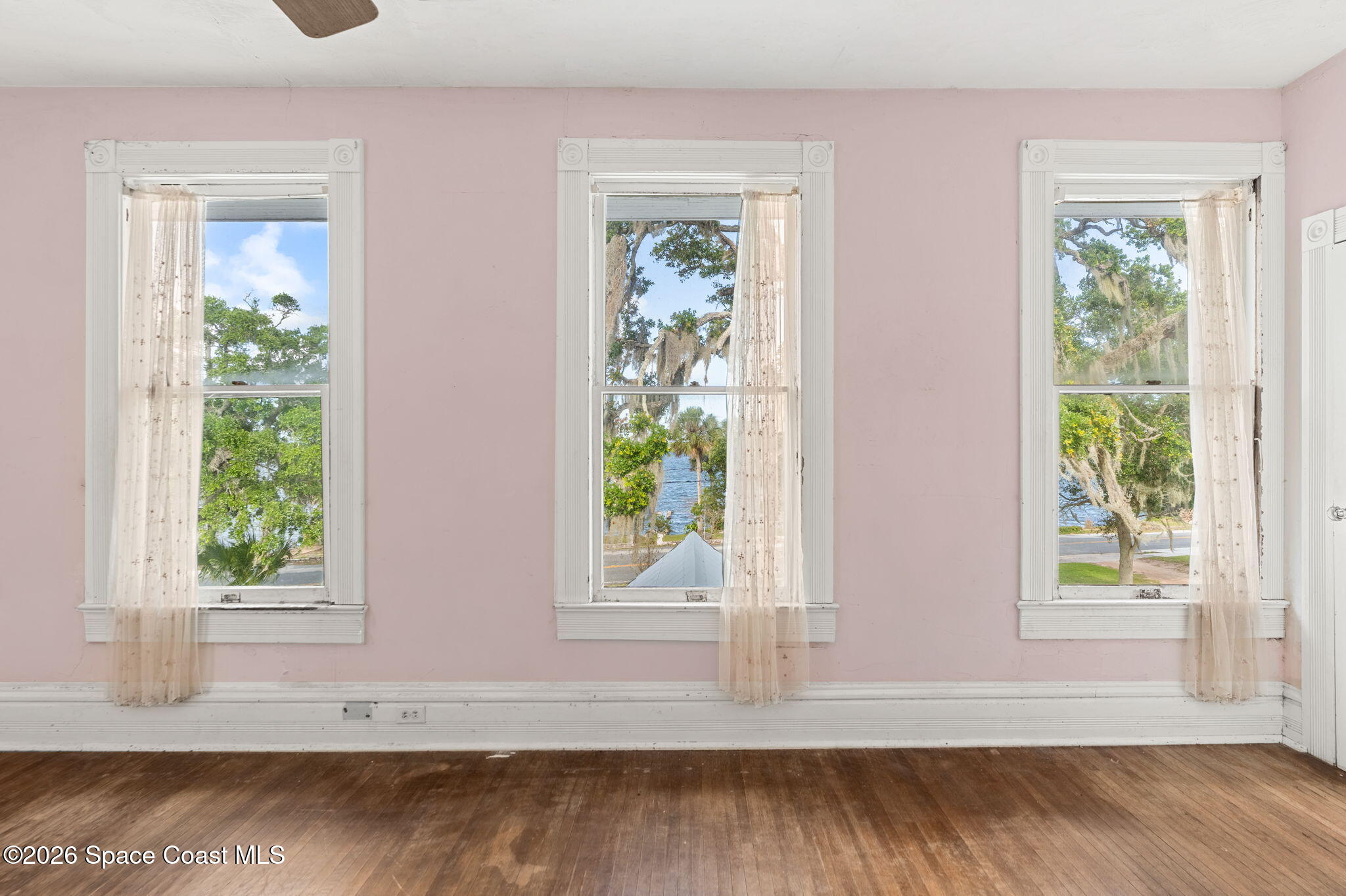 1101 Rockledge Drive Rockledge, FL 32955 - Photo 35 of 76 a view of an empty room with wooden floor and a window