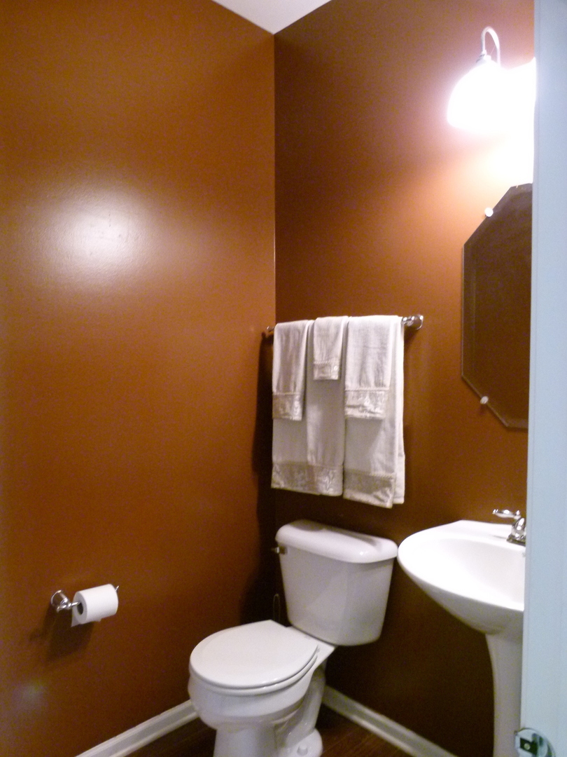 116 Jackson Street Gilberts, IL 60136 - Photo 15 of 19 a white toilet sitting next to a bathroom sink