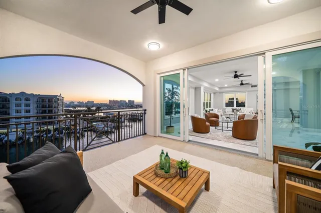 a living room with furniture a ceiling fan and a rug