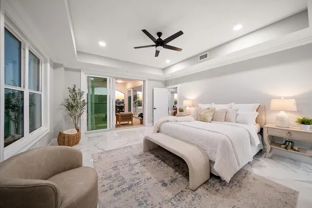 a spacious bedroom with a large bed and a large window